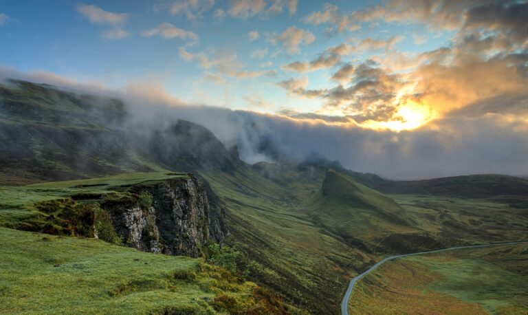 Low cloud rolling over a grassy ridge